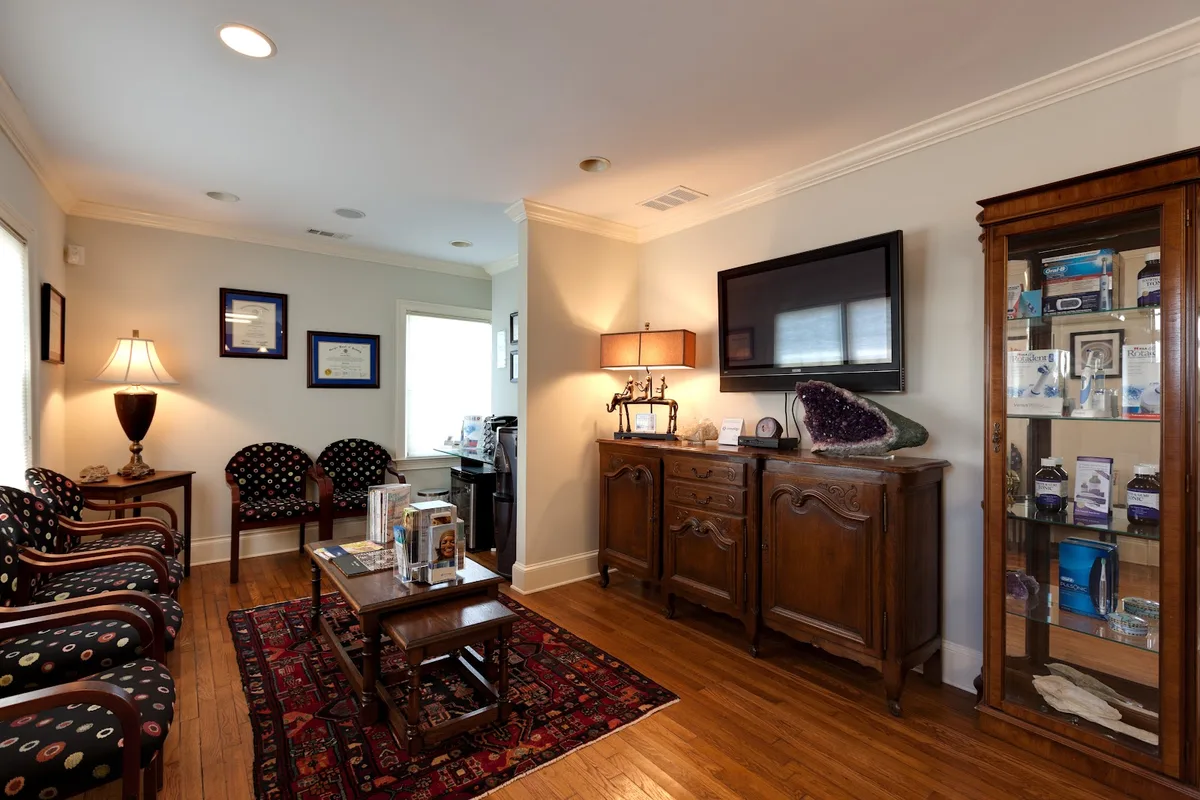 The warm, art-filled reception area at Atlanta Dental Arts